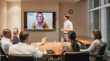 Photo of people in a video call in a meeting room