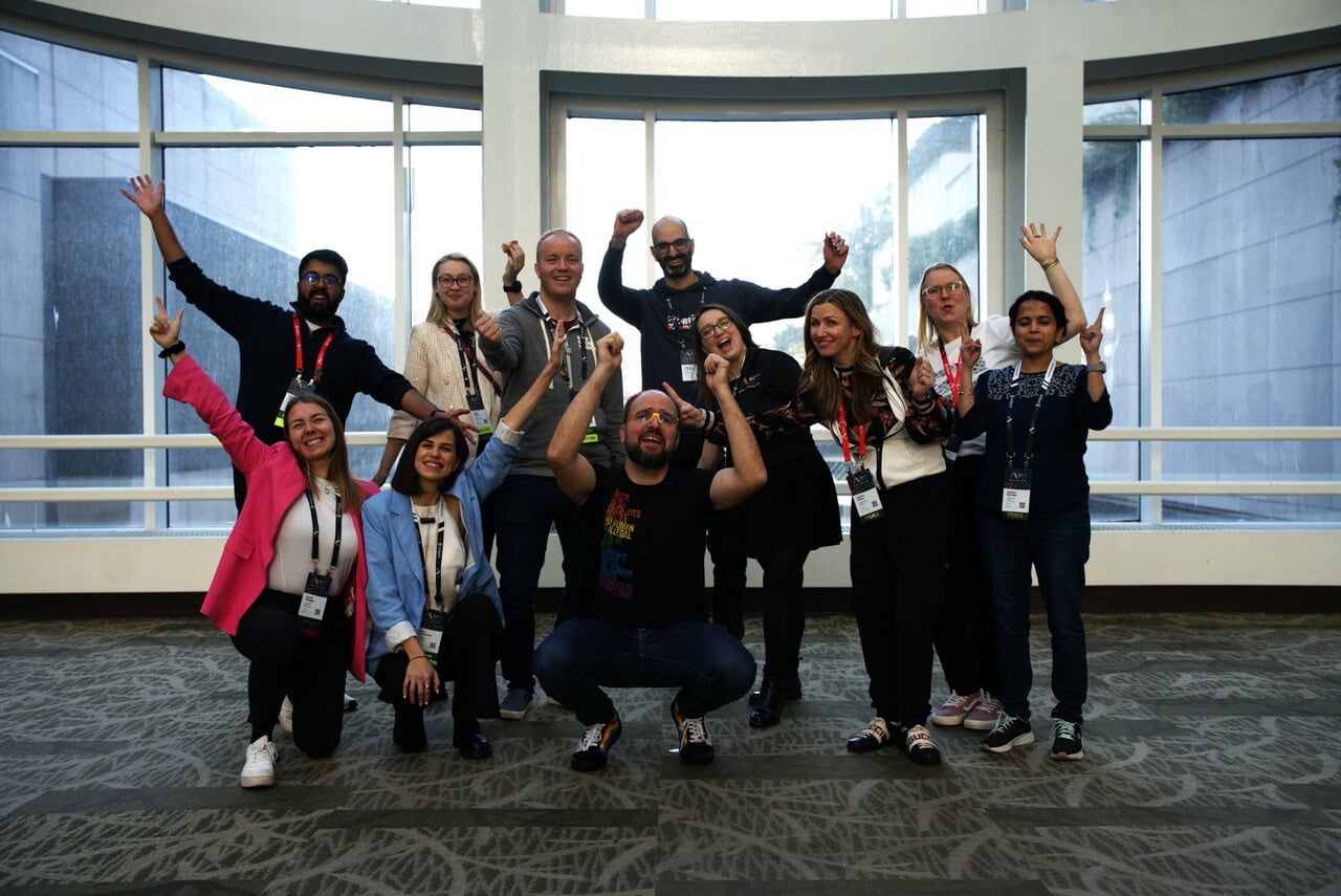 A small group of PASS Data Community Summit attendees, pictured together, joyful and in a celebratory mood